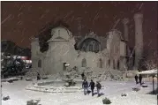  ?? DIA IMAGES VIA AP ?? People walk next to a mosque destroyed by an earthquake in Malatya, Turkey, Feb. 6, 2023. A powerful quake has knocked down multiple buildings in southeast Turkey and Syria and many casualties are feared.