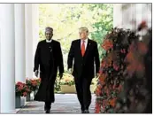  ?? OLIVIER DOULIERY/ABACA PRESS ?? President Donald Trump and Nigeria’s Muhammadu Buhari walk outside the White House.