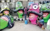  ??  ?? An artist paints an effigy of demon king Ravan ahead of the forthcomin­g Dushera festival, at Titarpur, Tagore Garden, in New Delhi, on Sunday