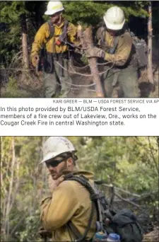  ?? KARI GREER — BLM — USDA FOREST SERVICE VIA AP ?? In this photo provided by BLM/USDA Forest Service, members of a fire crew out of Lakeview, Ore., works on the Cougar Creek Fire in central Washington state.