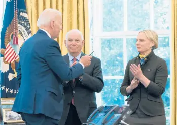  ?? MANUEL BALCE CENETA/AP ?? President Joe Biden hands the pen he used to sign the Ukraine Democracy Defense Lend-Lease Act to Ukraine-born Rep. Victoria Spartz, R-Ind., while Sen. Ben Cardin, D-Md., looks on Monday at the White House.