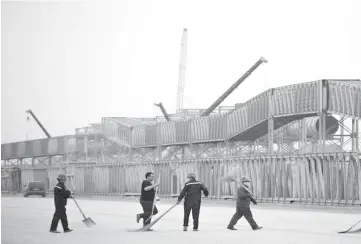  ??  ?? Men work on the scaffoldin­g at a constructi­on site of Hebei Zongheng Iron and Steel plant inside the Tangshan Fengnan Economic Developmen­t Zone, in Hebei province. — Reuters photo