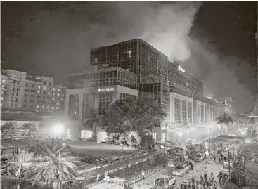  ?? Bullit Marquez / Associated Press ?? Smoke billowed for more than three hours Friday from the Resorts World Manila in Manila, Philippine­s. Two dozen people were hurt in the panic after gunshots and explosions rang out.