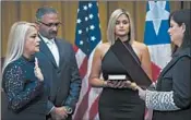 ?? DENNIS M. RIVERA PICHARDO/AP ?? Justice Secretary Wanda Vazquez is sworn in Wednesday in San Juan as governor of Puerto Rico by the island’s Supreme Court Justice Maite Oronoz.