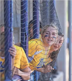  ?? PHOTOS BY NATHAN J FISH/THE OKLAHOMAN ?? Moss players lean against the net during the Class B state fastpitch softball quarterfinals Thursday against Lookeba-Sickles High School at the USA Softball Hall of Fame Stadium Complex.