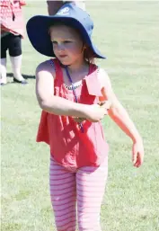  ??  ?? Sienna Pyart lines up her throw in the ring toss.