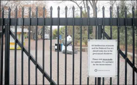  ?? CAROLYN KASTER/AP ?? A closed sign is posted Wednesday on the gate of Smithsonia­n’s National Zoo in Washington.
