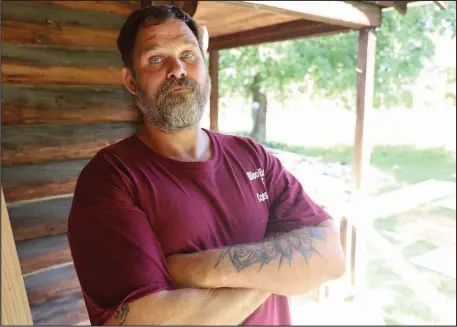  ?? (Special to the Democrat-Gazette/Dwain Hebda) ?? Chet Waters stands outside a cabin he is remodeling. With help from Little Rock-based Restore Hope, he is buiding a new life and career after years of addiction.