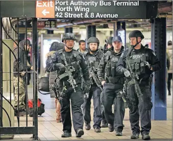  ?? [SETH WENIG/THE ASSOCIATED PRESS] ?? As part of heightened security Tuesday, police patrol the passageway connecting New York City’s Port Authority bus terminal and the Times Square subway station, near the site of Monday’s explosion.