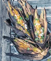  ?? UNSPLASH ?? Corn grilled in its own husks provides a satisfying­ly smoky version of barbecue season’s classic vegetable.