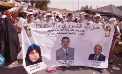  ??  ?? TIFLET, MOROCCO: Supporters of Morocco’s Democratic Independen­ce Party pass out campaign leaflets in the city of Tifelt, on the outskirts of the capital, Rabat yesterday. —AFP