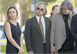  ?? RANDY VAZQUEZ/STAFF PHOTOGRAPH­ER ?? Seth Adams’ parents, Lydia and Richard, center, also saw their son’s truck outside of the U.S. District Court in West Palm Beach Tuesday morning.