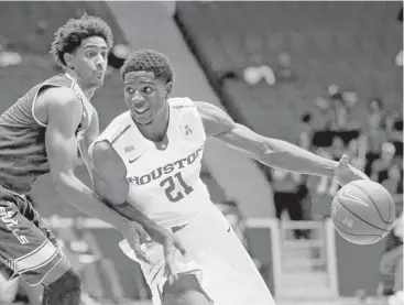  ?? Gary Coronado / Houston Chronicle ?? UH guard Damyean Dotson, right, had his way with South Florida’s Nehemias Morillo and other American Athletic Conference foes. Dotson was first-team AAC before becoming a second-round pick of the Knicks.