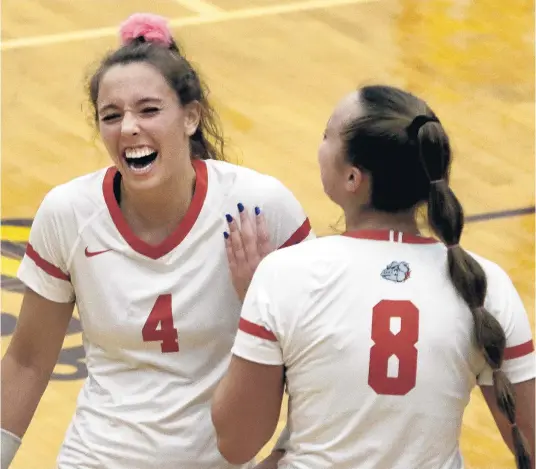  ?? JOHN SMIERCIAK/POST-TRIBUNE ?? Crown Point’s Kyla Oppenhuis, left, and Kendall Schara congratula­te each other during the Class 4A Hobart Sectional final against Valparaiso on Saturday.