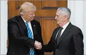  ?? CAROLYN KASTER/AP ?? President-elect Donald Trump shakes hands with retired Marine Corps Gen. James Mattis after meeting Nov. 19.