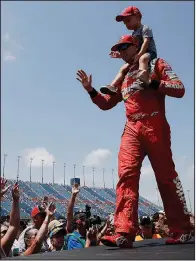  ?? AP/NAM Y. HUH ?? Kyle Busch and his son, Brexton, greet fans before a NASCAR Cup Series race July 1 at Chicagolan­d Speedway in Joliet, Ill. Busch is among three drivers who have a legitimate shot at winning this year’s championsh­ip.