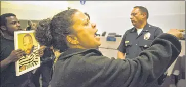 ?? Kent Nishimura
Los Angeles Times ?? CAL STATE L.A. professor Melina Abdullah joins protesters at Tuesday’s L.A. Police Commission hearing at LAPD headquarte­rs. “It’s a completely corrupt system,” she says of the way police shootings are investigat­ed.