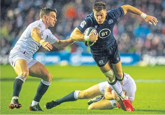  ?? Picture: SNS. ?? Huw Jones, seen here making a break against England, has been replaced by the more defensivel­y-minded Chris Harris.