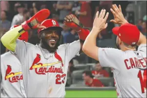  ?? The Associated Press ?? DOUBLE-DOUBLE: St. Louis Cardinals’ Marcell Ozuna (23) celebrates his two-run double against the Atlanta Braves Thursday in the ninth inning during Game 1 of the National League Division Series in Atlanta.