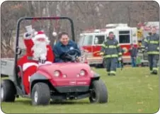  ??  ?? Santa arrives aboard a Torro Workman after being escorted to the park by members of the Newtown Fire Associatio­n.