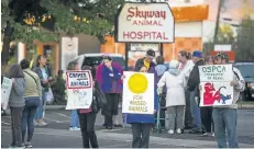  ?? BOB TYMCZYSZYN/POSTMEDIA NETWORK ?? A large group turned out for a Monday night vigil outside the Skyway Animal Hospital on Welland Avenue in St. Catharines. Dr. Mahavir Singh Rekhi was suspended by the College of Veterinari­ans of Ontario for profession­al misconduct earlier this year.