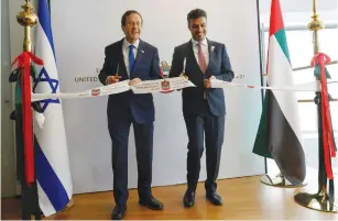  ?? (Amir Cohen/Reuters) ?? PRESIDENT ISAAC HERZOG and UAE Ambassador Mohamed Al Khaja cut a ribbon during the opening ceremony of the Emirati Embassy in Tel Aviv yesterday.