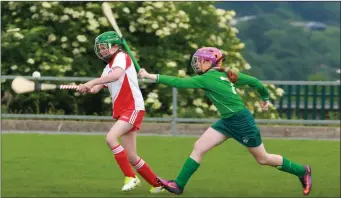  ??  ?? Caoimhe Furlong of Kilanerin strikes under heavy pressure from Erin McDonald (Clonroche).