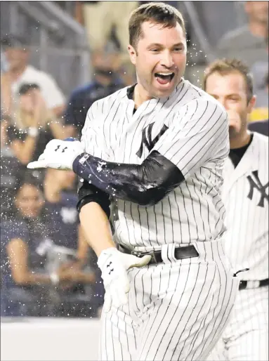  ?? Bill Kostroun / Associated Press ?? The Yankees’ Neil Walker celebrates after hitting a pinch-hit, walk-off home run to beat the White Sox 5-4 on Tuesday night in New York.