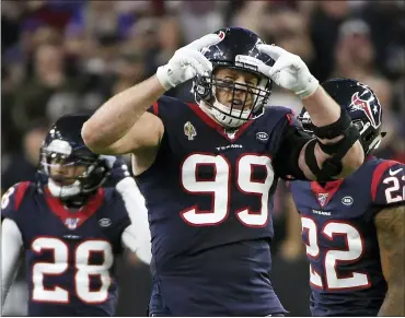  ?? ASSOCIATED PRESS FILE PHOTO ?? Then-Houston Texans defensive end J.J. Watt, center, celebrates during the second half of the 2020NFL wild-card playoff game against the Buffalo Bills in Houston. Watt has agreed to a two-year contract with the Arizona Cardinals. The team announced the deal with the free-agent edge rusher on Monday. Watt was released last month by the Texans.