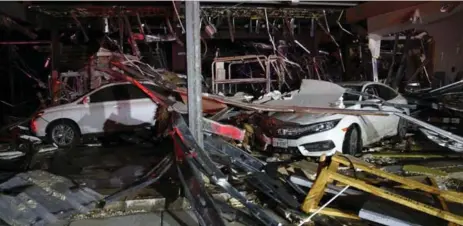  ?? TOM FOX/THE ASSOCIATED PRESS ?? Tornadoes flipped vehicles at a Dodge dealership in Canton, Texas. “It is heartbreak­ing and upsetting to say the least,” said Mayor Lou Ann Everett.