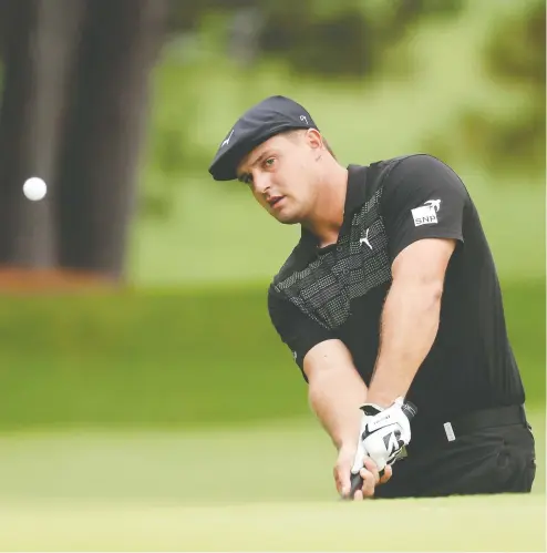  ?? ROB CARR / GETTY IMAGES ?? Bryson DeChambeau wasn't completely satisfied with his first round at Augusta National Thursday, but still shot 2-under.