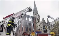  ?? Yuki Iwamura / Associated Press ?? Firefighte­rs work to extinguish the early morning blaze Saturday at Middle Collegiate Church in New York. The historic Manhattan church houses New York's Liberty Bell.
