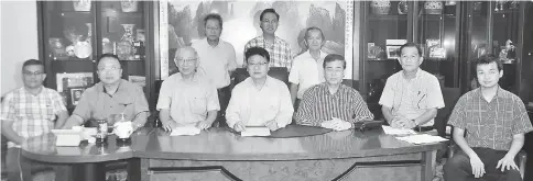  ??  ?? Ngui (seated centre) in a group photo with his members.