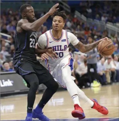  ?? JOHN RAOUX — THE ASSOCIATED PRESS FILE ?? Sixers depth point guard Markelle Fultz, right, here driving around Orlando’s Jerian Grant last week, plans to pay a visit to a shoulder specialist in New York and won’t practice or play until he does so.
