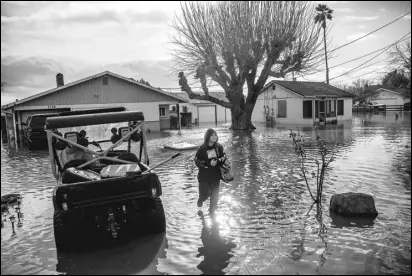  ?? ASSOCIATED PRESS FILES ?? Brenda Ortega, 15, salvages items from her flooded Merced home, earlier this month. In California, only about 230,000 homes and other buildings have flood insurance policies, which are separate from homeowners insurance.