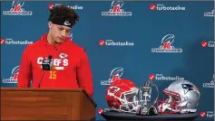  ??  ?? Kansas City Chiefs quarterbac­k Patrick Mahomes looks at the Lamar Hunt Trophy during a news conference in Kansas City, Mo., on Wednesday ahead of the AFC Championsh­ip game against the New England Patriots.