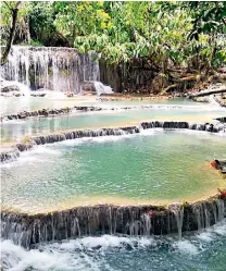  ??  ?? GO WITH THE FLOWThe Khouangxi waterfalls in Laos; a Buddha statue, below