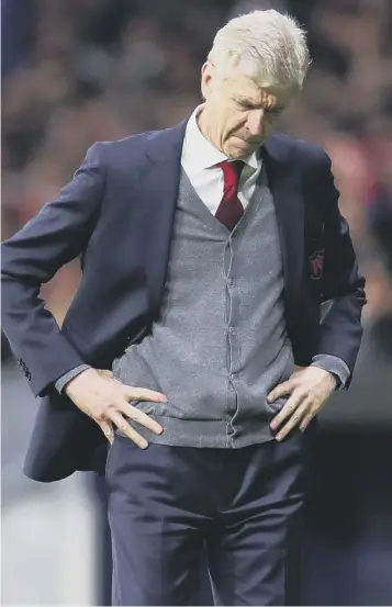  ??  ?? 0 Departing Arsenal boss Arsene Wenger cuts a disconsola­te figure in Madrid last night.