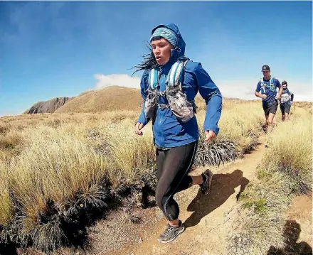  ??  ?? Jo Johansen training at Mt Hector in the sun, the week before the Tararua Mountain Race.