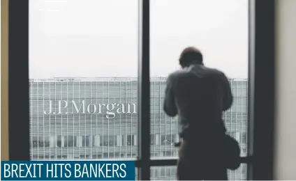 ?? Picture: Bloomberg ?? A man looks across to the offices of JPMorgan Chase & Co in London yesterday. JPMorgan is to move hundreds of London-based bankers to Dublin, Frankfurt and Luxembourg after Brexit, the firm says.