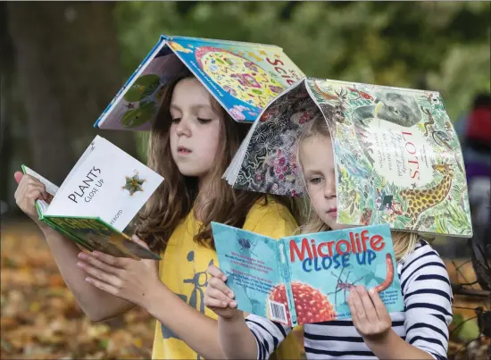  ??  ?? Clara and Meabh Deane enjoy Science Storytime ahead of Cork Science Festival, which runs from November 11 to 18. Cork libraries will be hosting Science Storytime during the week, with science readings, talks and colouring to celebrate science in our everyday lives