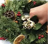  ??  ?? Cuttings from the Christmas tree, pine cones, berries and dried orange slices can all be used to great effect