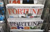  ?? Mario Tama Getty Images ?? THE SALE of Fortune includes related businesses. Above, copies of Fortune are sold in New York in 2013.