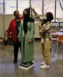  ?? ?? With Mrs. Brown’s guidance, Fahima Aktar and Nowrin Rahman learn the importance of accurately measuring and recording height and weight.