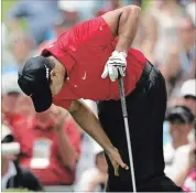  ?? ASSOCIATED PRESS FILE PHOTO ?? Tiger
Woods grabs his left knee after teeing off on the second hole during the fourth round of the U.S. Open at Torrey Pines 10 years ago.