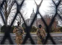  ?? SALWAN GEORGES/WASHINGTON POST ?? Members of the National Guard are seen behind a security fence at the U.S. Capitol on Friday.