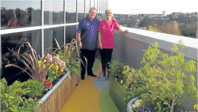  ??  ?? ▼ Volunteers including Lisella Hutton transforme­d the balconies to create a beautiful setting.