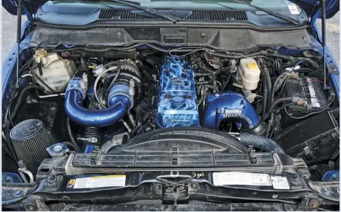  ??  ?? Lifting the bright blue hood reveals the 5.9L common-rail Cummins diesel engine in all of its compound-turbo glory. Notice the bright blue powder coating that brings the body color into the engine bay.