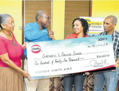  ?? CONTRIBUTE­D ?? Alphonso Grennell (second left), managing director of Grennell’s Driving School, shakes hands with Sherianne Thompson Hart, business manager at Salada Foods Jamaica, for the continued support of the company for the ninth staging of the Grennell’s Road Safety 5K race during the launch event at the Ministry of Transport and Mining on November 1. Sharing in the moment are Claudia and Errol Alliman, parents of crash victim, Jason Alliman, the race is being held.