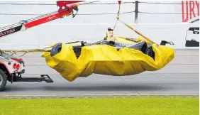  ?? Photo / Getty Images ?? A damaged car is bagged and towed after yesterday’s crash.